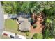 An aerial view of the home features a well-kept lawn and mature trees surrounding the property at 3918 Windgrove Xing, Suwanee, GA 30024