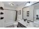 Well-lit bathroom featuring a vanity with a large framed mirror and a shower-tub combo at 3918 Windgrove Xing, Suwanee, GA 30024