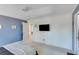Comfortable bedroom with blue accent wall and mounted TV at 3918 Windgrove Xing, Suwanee, GA 30024