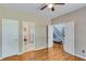 Spacious bedroom with hardwood floors and multiple doorways at 3918 Windgrove Xing, Suwanee, GA 30024