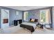 Light blue bedroom with carpet, windows, and plenty of space for both study and rest at 3918 Windgrove Xing, Suwanee, GA 30024