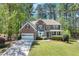 Charming two-story brick home with a well-manicured lawn, attached garage, and inviting front porch at 3918 Windgrove Xing, Suwanee, GA 30024