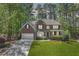 Charming two-story brick home with a well-manicured lawn, attached garage, and inviting front porch at 3918 Windgrove Xing, Suwanee, GA 30024
