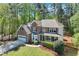Beautiful two-story brick home with attached garage and manicured front lawn in a serene, wooded setting at 3918 Windgrove Xing, Suwanee, GA 30024