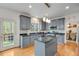 Well-equipped kitchen boasts granite countertops, center island, stainless appliances, and access to the backyard at 3918 Windgrove Xing, Suwanee, GA 30024