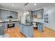 Modern kitchen with stainless appliances, granite counters, island seating, and adjacent breakfast nook at 3918 Windgrove Xing, Suwanee, GA 30024