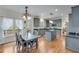 Open concept kitchen features granite counters, stainless appliances, access to deck, and adjacent dining area at 3918 Windgrove Xing, Suwanee, GA 30024