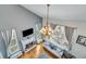 Two-story living room with a fireplace, oversized windows, and hardwood floors at 3918 Windgrove Xing, Suwanee, GA 30024
