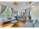 Spacious living room featuring high ceilings, large windows, and comfortable seating at 3918 Windgrove Xing, Suwanee, GA 30024
