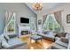Bright living room featuring a fireplace, large windows, and comfortable seating at 3918 Windgrove Xing, Suwanee, GA 30024