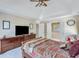 Spacious main bedroom with a trey ceiling, a ceiling fan, and a doorway to the en-suite bath at 3918 Windgrove Xing, Suwanee, GA 30024