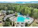 Aerial shot of a community pool and clubhouse, complemented by lush landscaping and outdoor seating areas at 3918 Windgrove Xing, Suwanee, GA 30024