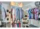 Organized walk-in closet featuring shelves for shoes and handbags and hanging rods for clothing at 3918 Windgrove Xing, Suwanee, GA 30024