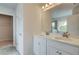 Bathroom with white cabinetry, dual vanity, tiled floors, and a glass-enclosed shower at 576 Teversham Dr, Mcdonough, GA 30253