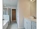 Bathroom with white cabinetry, dual vanity, tiled floors, and a glass-enclosed shower at 576 Teversham Dr, Mcdonough, GA 30253