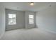 Bright bedroom with two windows allowing ample natural light to illuminate the space at 576 Teversham Dr, Mcdonough, GA 30253