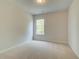 Cozy bedroom featuring neutral carpeting, bright natural light, and an airy ambiance at 576 Teversham Dr, Mcdonough, GA 30253