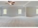 Spacious bonus room with plush carpeting and an elegant tray ceiling with a fan at 576 Teversham Dr, Mcdonough, GA 30253