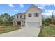 Beautiful two-story home with a two-car garage and an expansive lawn at 576 Teversham Dr, Mcdonough, GA 30253