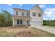 Well-maintained two-story home with a two-car garage and professionally landscaped front yard at 576 Teversham Dr, Mcdonough, GA 30253
