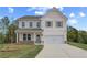 Inviting two-story home featuring a classic design and pristine landscaping at 576 Teversham Dr, Mcdonough, GA 30253