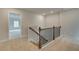 Upstairs hallway features neutral carpet and natural lighting at 576 Teversham Dr, Mcdonough, GA 30253