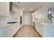 Modern kitchen features white cabinets, stainless appliances, and quartz countertops at 576 Teversham Dr, Mcdonough, GA 30253