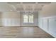 Spacious living area featuring coffered ceilings, stylish lighting, and hardwood floors at 576 Teversham Dr, Mcdonough, GA 30253