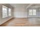 Bright living room featuring large windows, elegant trim, and hardwood floors, creating an inviting atmosphere at 576 Teversham Dr, Mcdonough, GA 30253