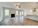 Bright open-concept living room with a fireplace, seamless flow to the kitchen, and hardwood floors at 576 Teversham Dr, Mcdonough, GA 30253