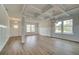 Open-concept living space with coffered ceilings, decorative trim, and beautiful hardwood flooring at 576 Teversham Dr, Mcdonough, GA 30253