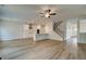 Open-concept living room and kitchen feature hardwood floors and modern finishes at 576 Teversham Dr, Mcdonough, GA 30253