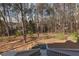 A serene backyard view from the back deck with lush trees and stairs at 6236 Benbrooke Nw Dr, Acworth, GA 30101
