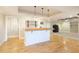 Finished basement with a built-in bar featuring pendant lighting and hardwood floors at 6236 Benbrooke Nw Dr, Acworth, GA 30101