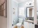 Powder room with blue accent wall, decorative mirror, wood look flooring and granite countertop vanity at 6236 Benbrooke Nw Dr, Acworth, GA 30101