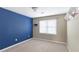 Bright bedroom featuring neutral colors, a bold blue accent wall, and natural light at 6236 Benbrooke Nw Dr, Acworth, GA 30101