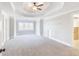 Large bedroom with a tray ceiling, ceiling fan, and natural light at 6236 Benbrooke Nw Dr, Acworth, GA 30101