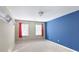 Bedroom featuring neutral colors, a bold blue accent wall, and natural light at 6236 Benbrooke Nw Dr, Acworth, GA 30101