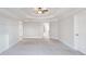 Large bedroom with a tray ceiling, ceiling fan, and neutral carpeting at 6236 Benbrooke Nw Dr, Acworth, GA 30101