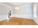Formal dining room with hardwood floors, elegant trim, and a modern chandelier creates a sophisticated ambiance at 6236 Benbrooke Nw Dr, Acworth, GA 30101