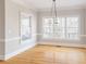 Traditional style dining room with custom moldings, decorative chandelier and large windows offering ample natural light at 6236 Benbrooke Nw Dr, Acworth, GA 30101