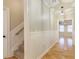 Hallway with hardwood floors and paneled walls leading to carpeted stairs and a room with natural light at 6236 Benbrooke Nw Dr, Acworth, GA 30101