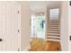 Hallway with hardwood floors leading to an open staircase and closet area with a white door at 6236 Benbrooke Nw Dr, Acworth, GA 30101