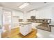 Modern kitchen features granite countertops, white cabinets, a kitchen island and stainless steel appliances for an upgraded, stylish feel at 6236 Benbrooke Nw Dr, Acworth, GA 30101