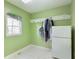 Practical laundry room with a window, neutral flooring, and a convenient refrigerator for added functionality at 6236 Benbrooke Nw Dr, Acworth, GA 30101
