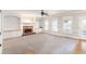 Spacious living room with a brick fireplace, built-in shelving, and large windows offers cozy elegance at 6236 Benbrooke Nw Dr, Acworth, GA 30101