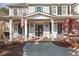 Charming front porch with classic white columns, brick flooring, and a cozy porch swing creates an inviting entrance at 6236 Benbrooke Nw Dr, Acworth, GA 30101