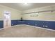 Carpeted bonus room with wainscoting and a view to an adjacent bathroom at 6236 Benbrooke Nw Dr, Acworth, GA 30101