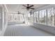Bright sun room with walls of windows, ceiling fans, and hardwood floors at 6236 Benbrooke Nw Dr, Acworth, GA 30101