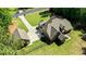 An aerial view of a luxurious home with a well-manicured lawn, complemented by a detached garage and fenced yard at 105 Chantilly Ln, Fayetteville, GA 30215